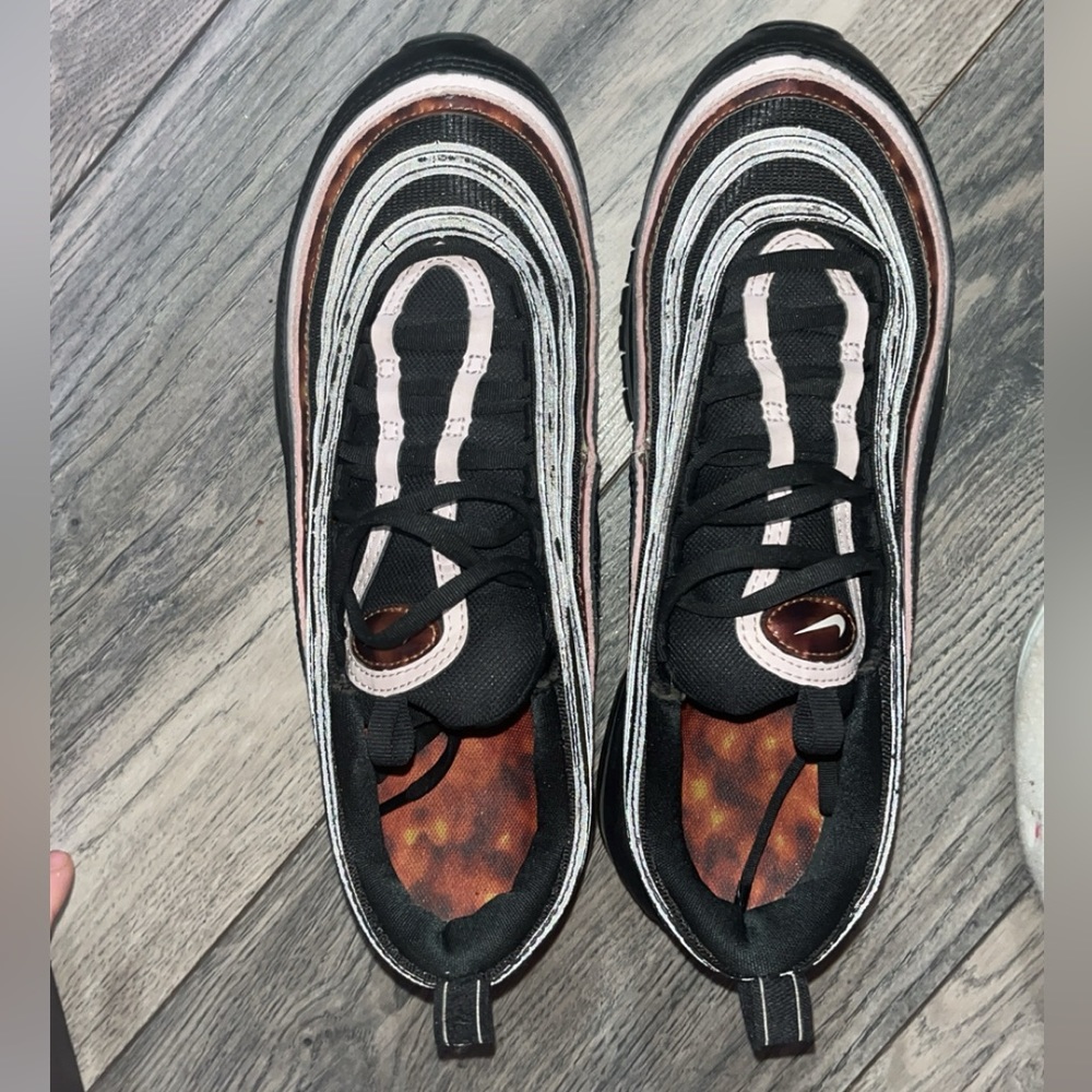 Black Nikes are a Size 7 . New Balance are a size 8